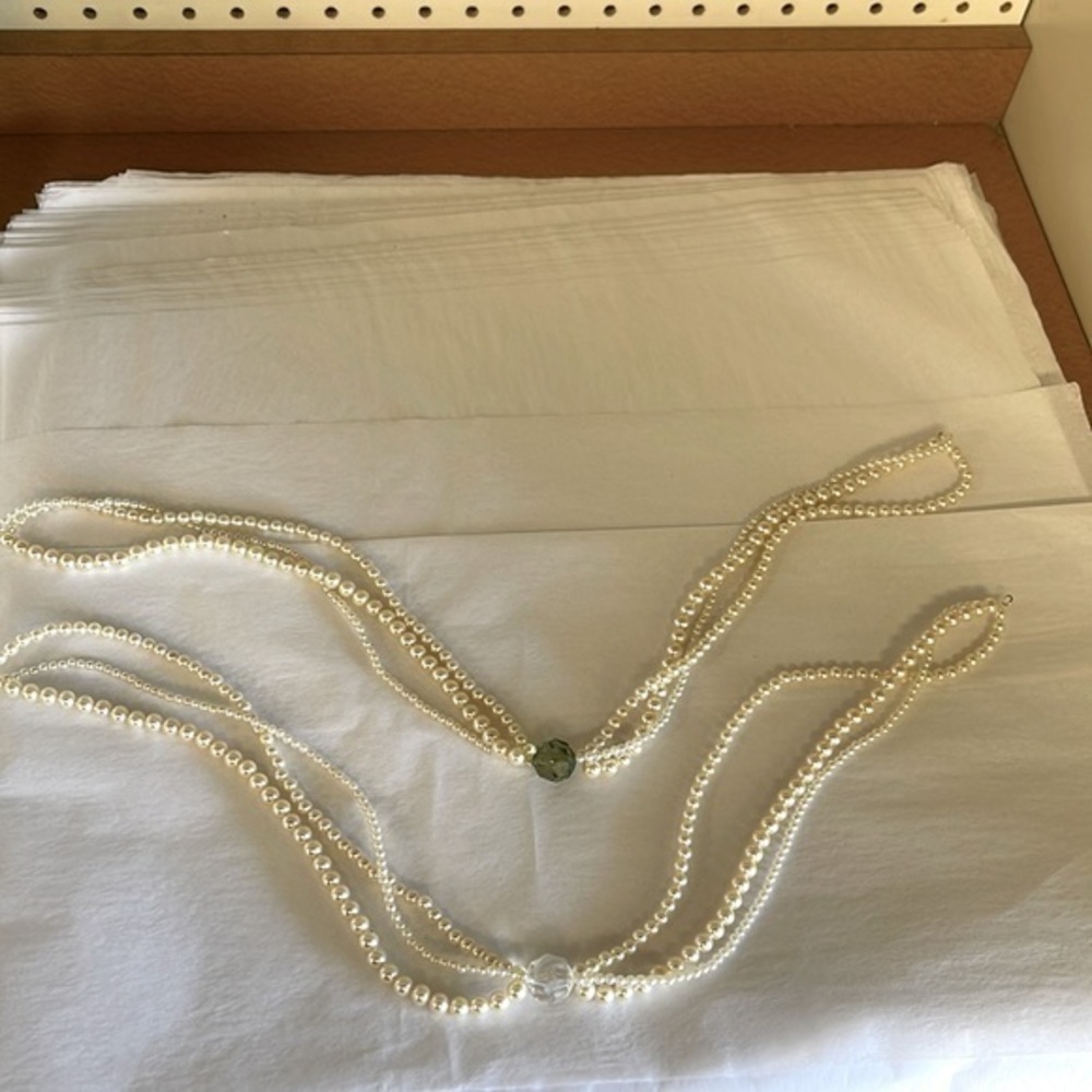 Costume jewelry triple strand of pearls with a plastic bead